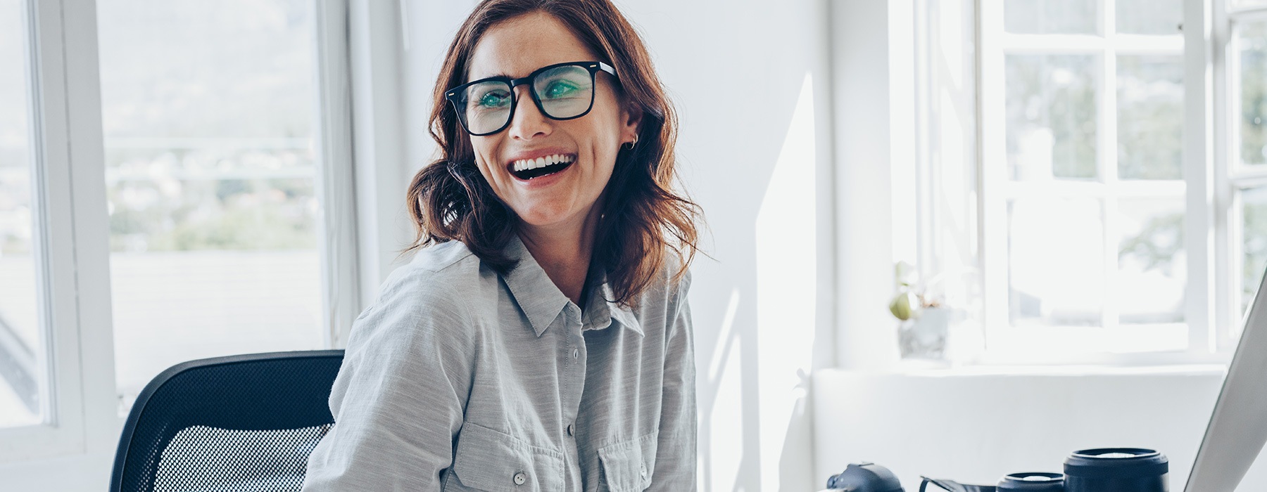 lifestyle image of a woman laughing and working